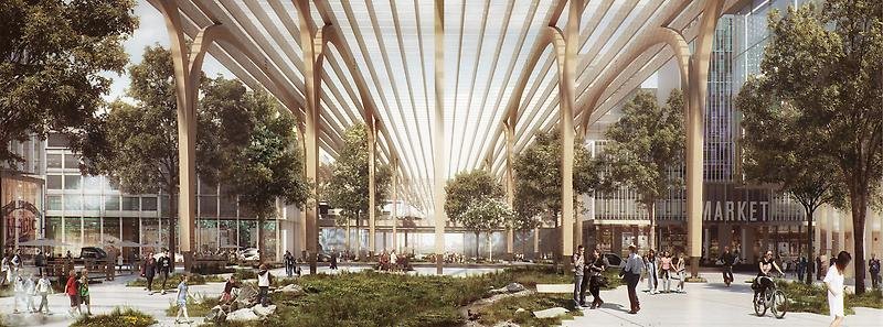 Ett torg under tak. På torget får människor bland grönskande träd.